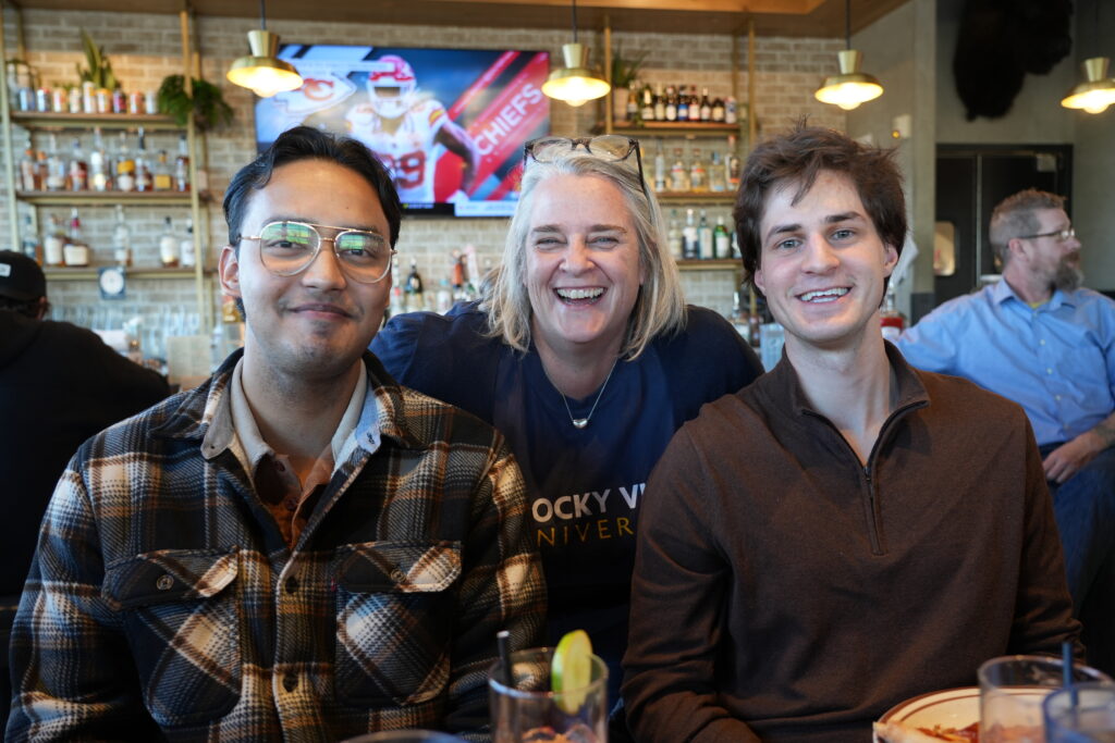 Two international students posed for photo with Director of International Scholar Success