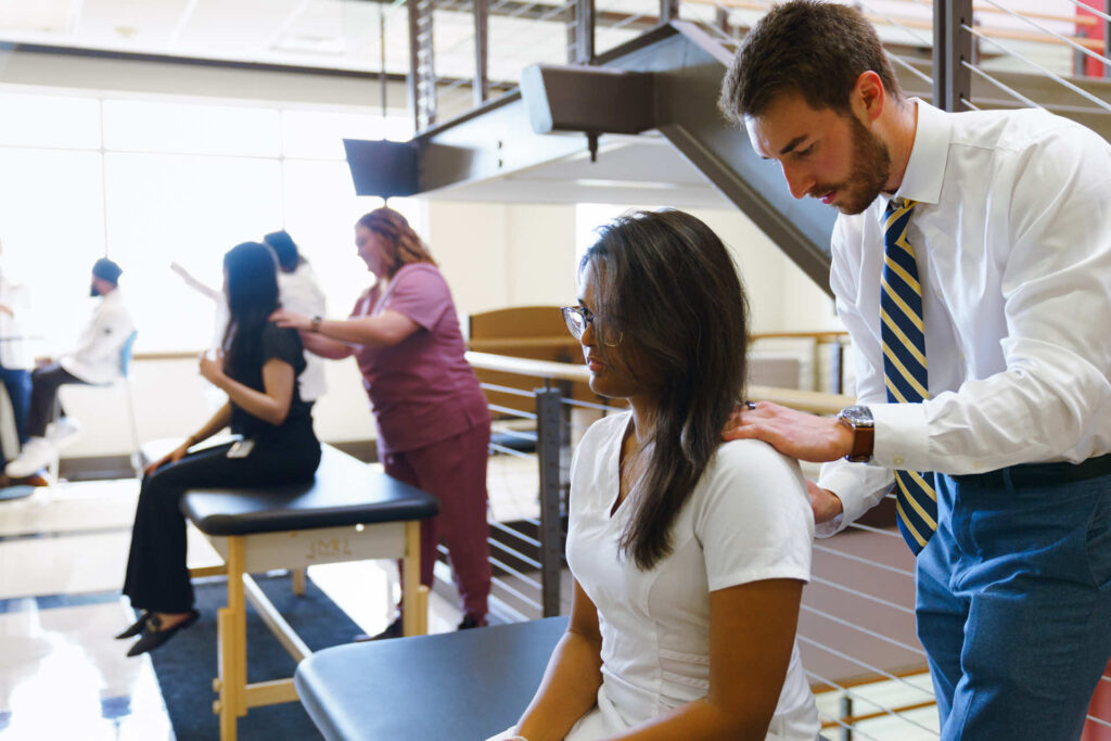 Student providing Osteopathic Manipulation treatment for another student.